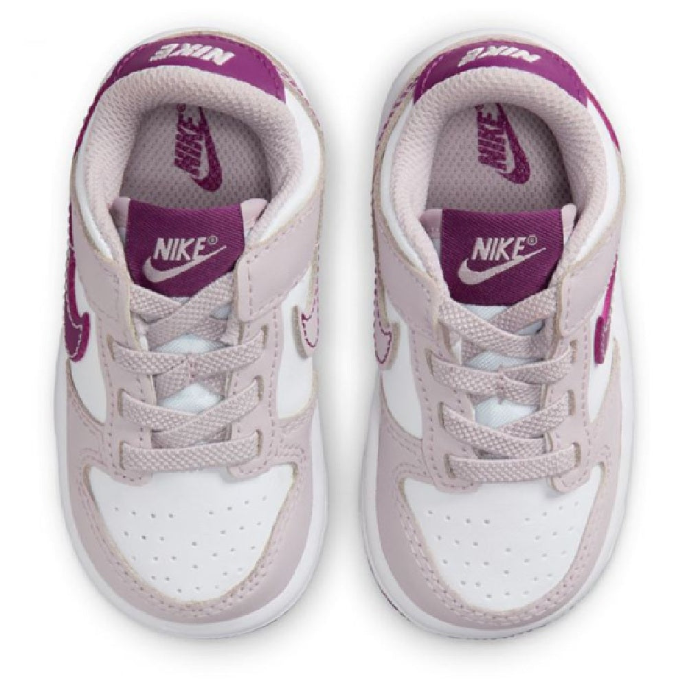 Toddler Nike Dunk Low sneakers, top view of tongue with violet Nike branding
