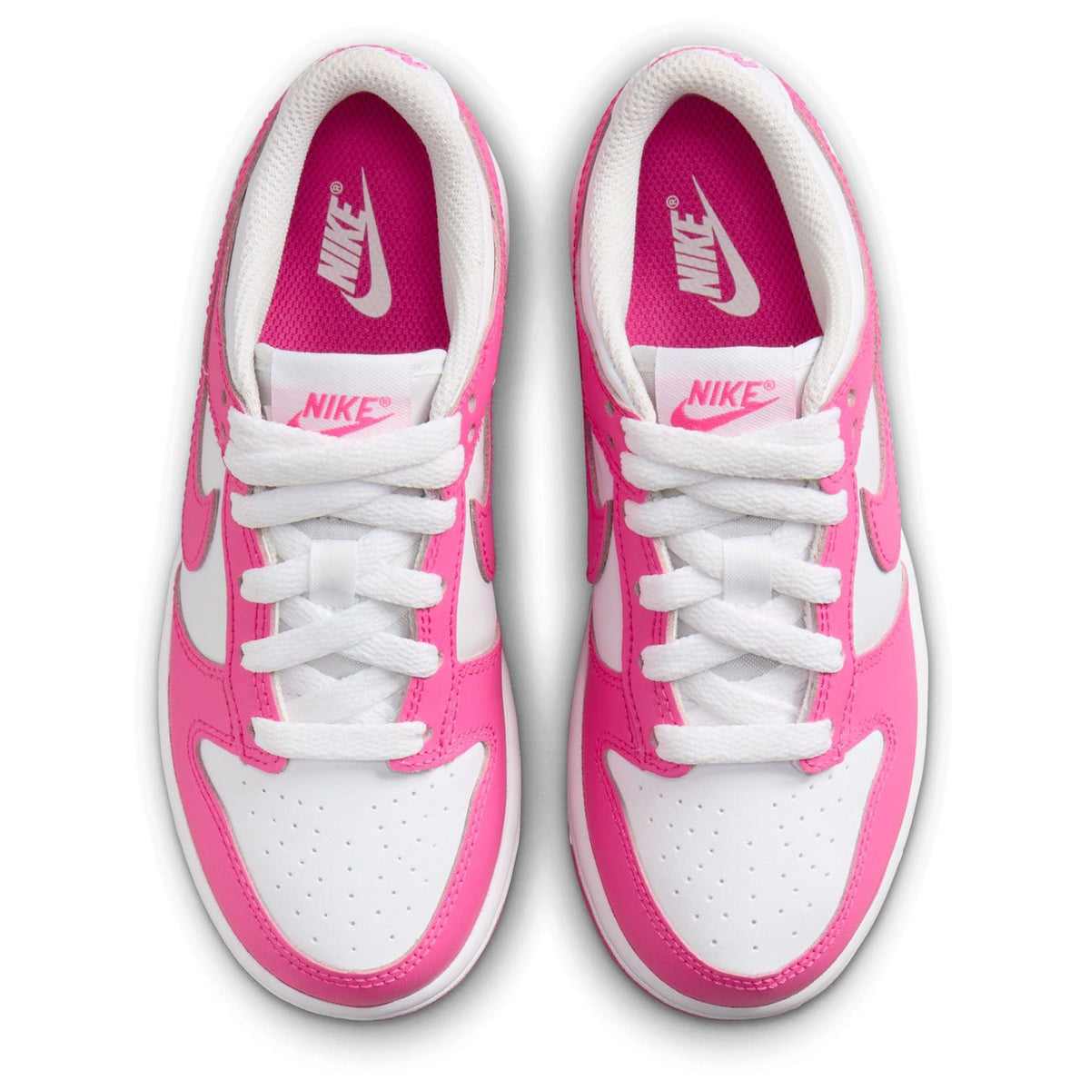 Kids' Nike Dunk Low sneakers, white toe with fuchsia sides, laces, and Nike tongue