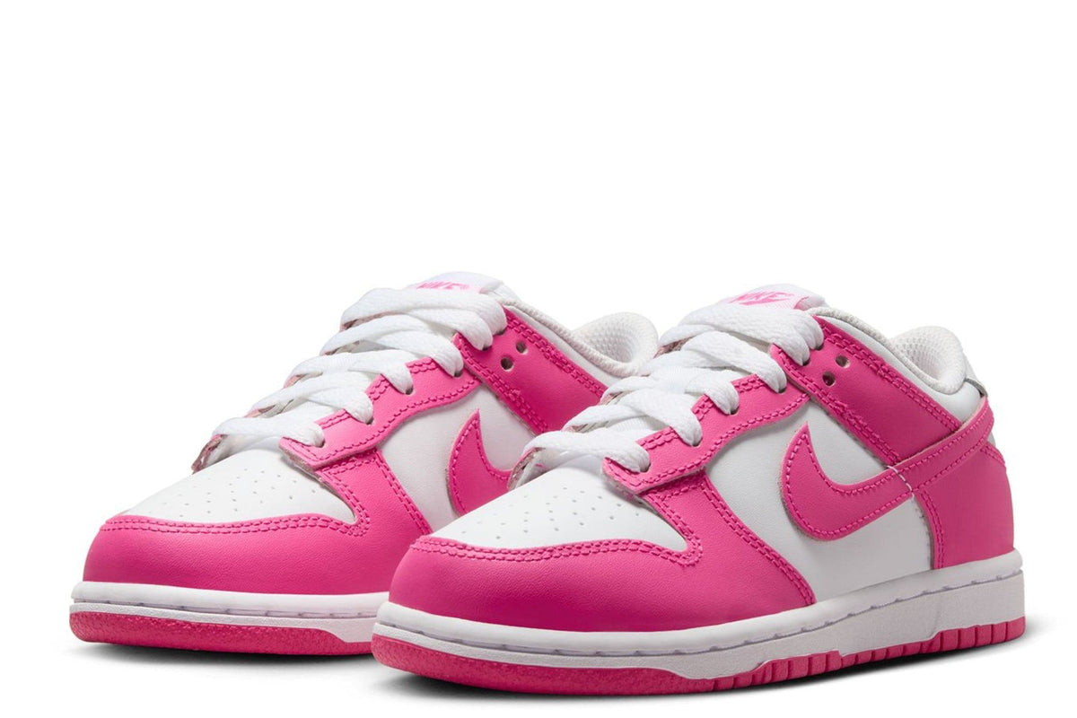 Pair of kids' Nike Dunk Low sneakers, white with fuchsia overlays and white laces