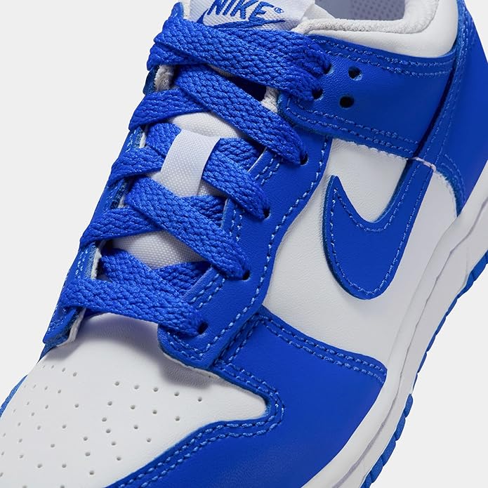 Nike Dunk Low kids sneaker close-up: Hyper Royal blue laces and white swoosh