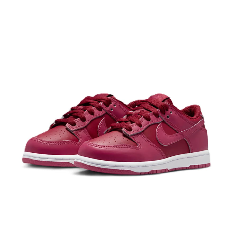 Kids' Nike Dunk Low lace-up sneakers, pink upper with swoosh, front view, white outsole.