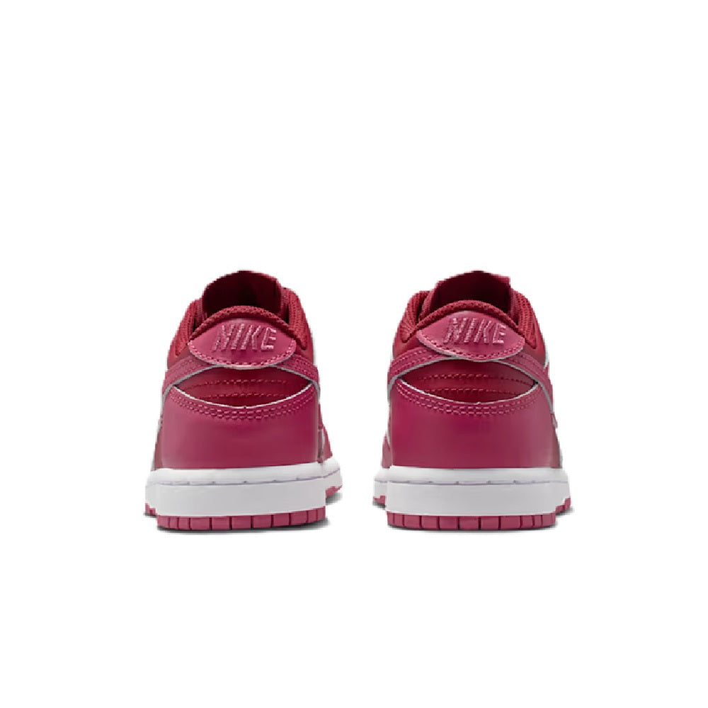 Kids' Nike Dunk Low sneakers, back view with Nike heel tabs, pink upper, white sole.