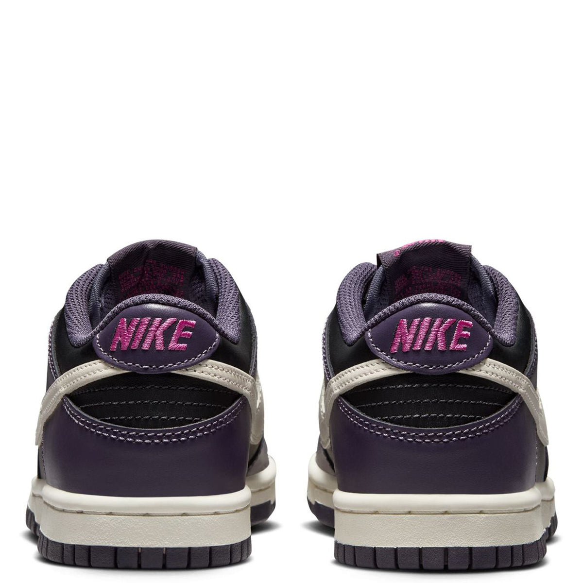 Kids' sneakers from the back: Nike logo on heel, dark purple uppers, white midsole