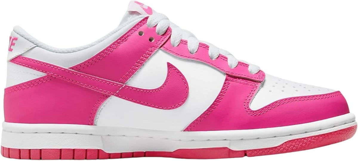 Nike Dunk Low big kid sneakers, white panels with hot pink overlays and Swoosh, side view