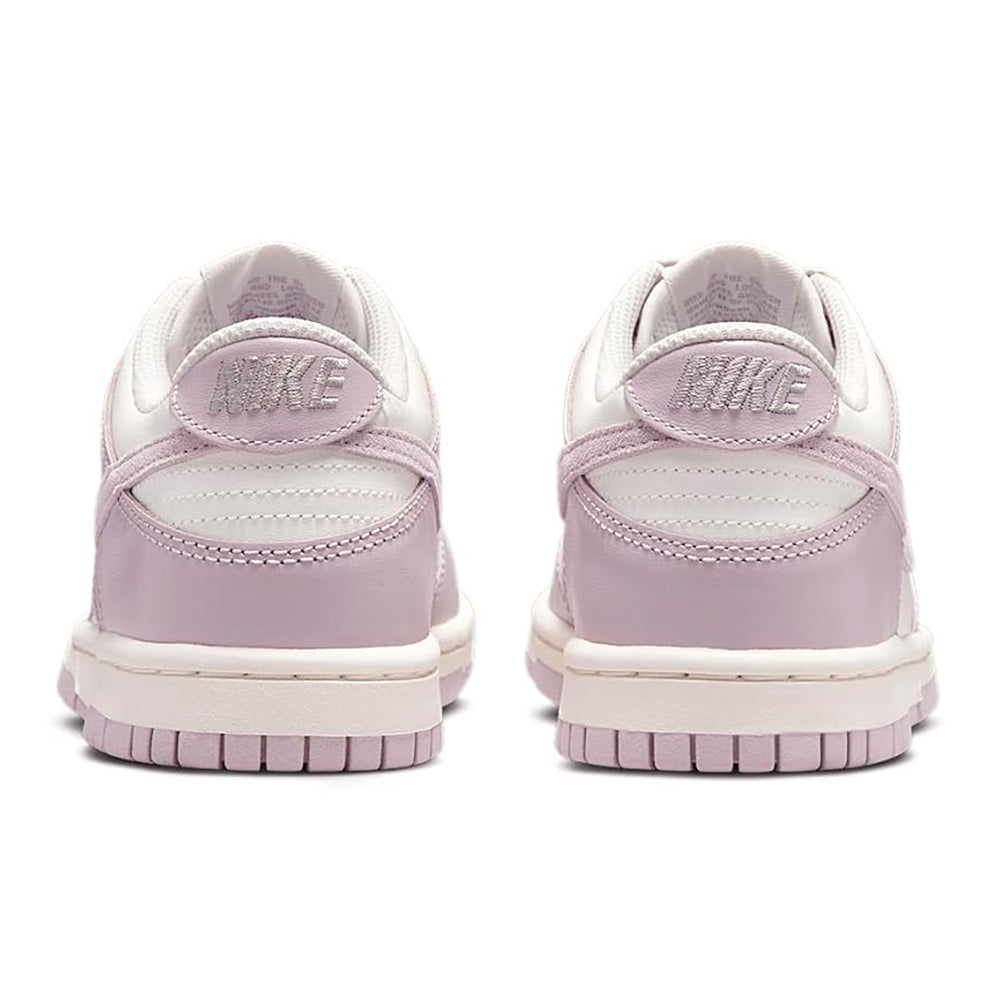 Big kid's Nike Dunk Low sneakers, heel tab branding and rose panels, rear view.