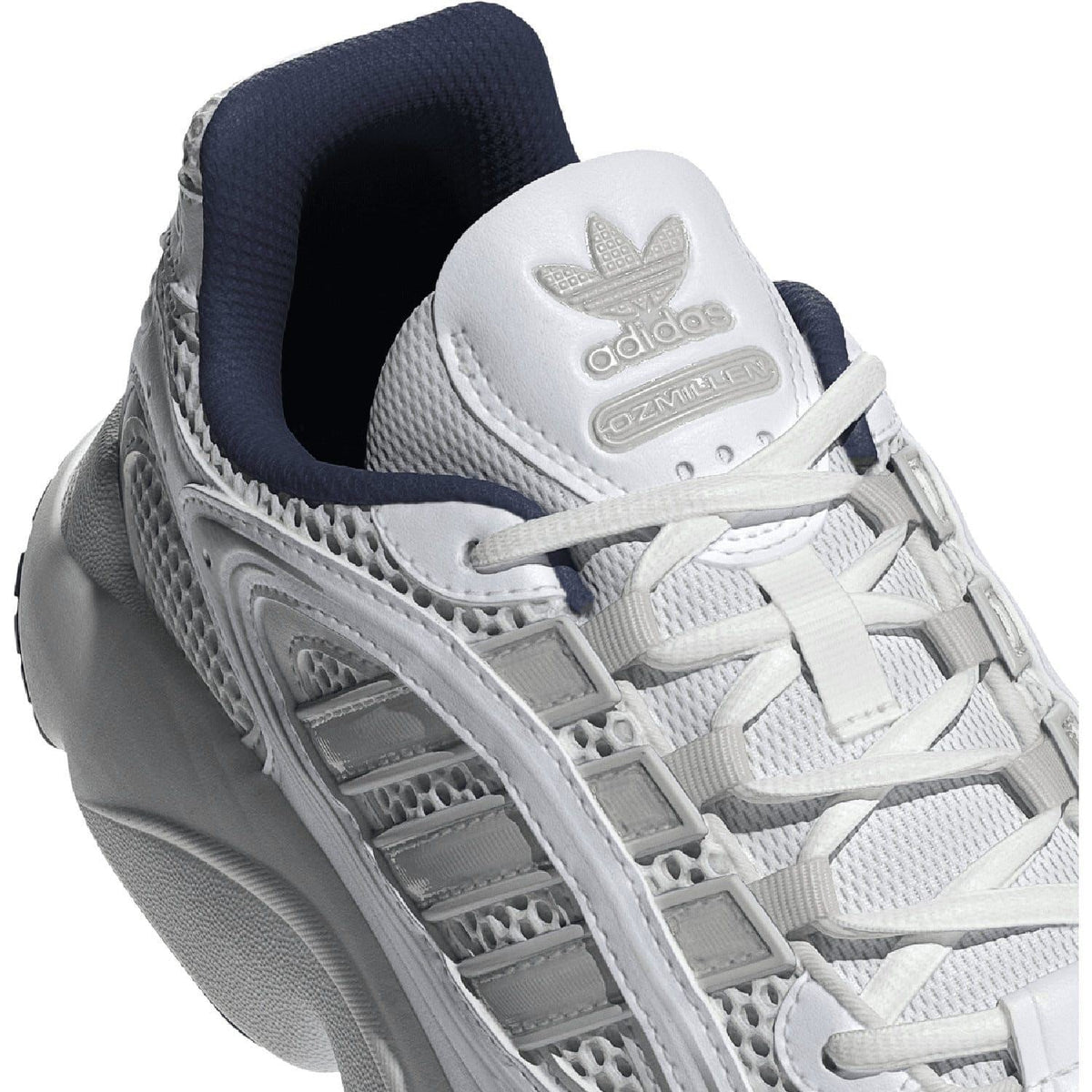 White trainers upper close-up with laces and adidas logo patch