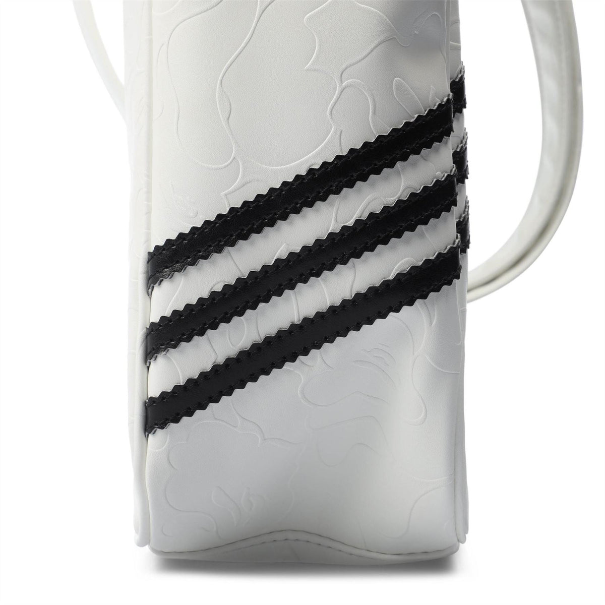White embossed adidas Originals BAPE bag with black triple stripe graphic on side