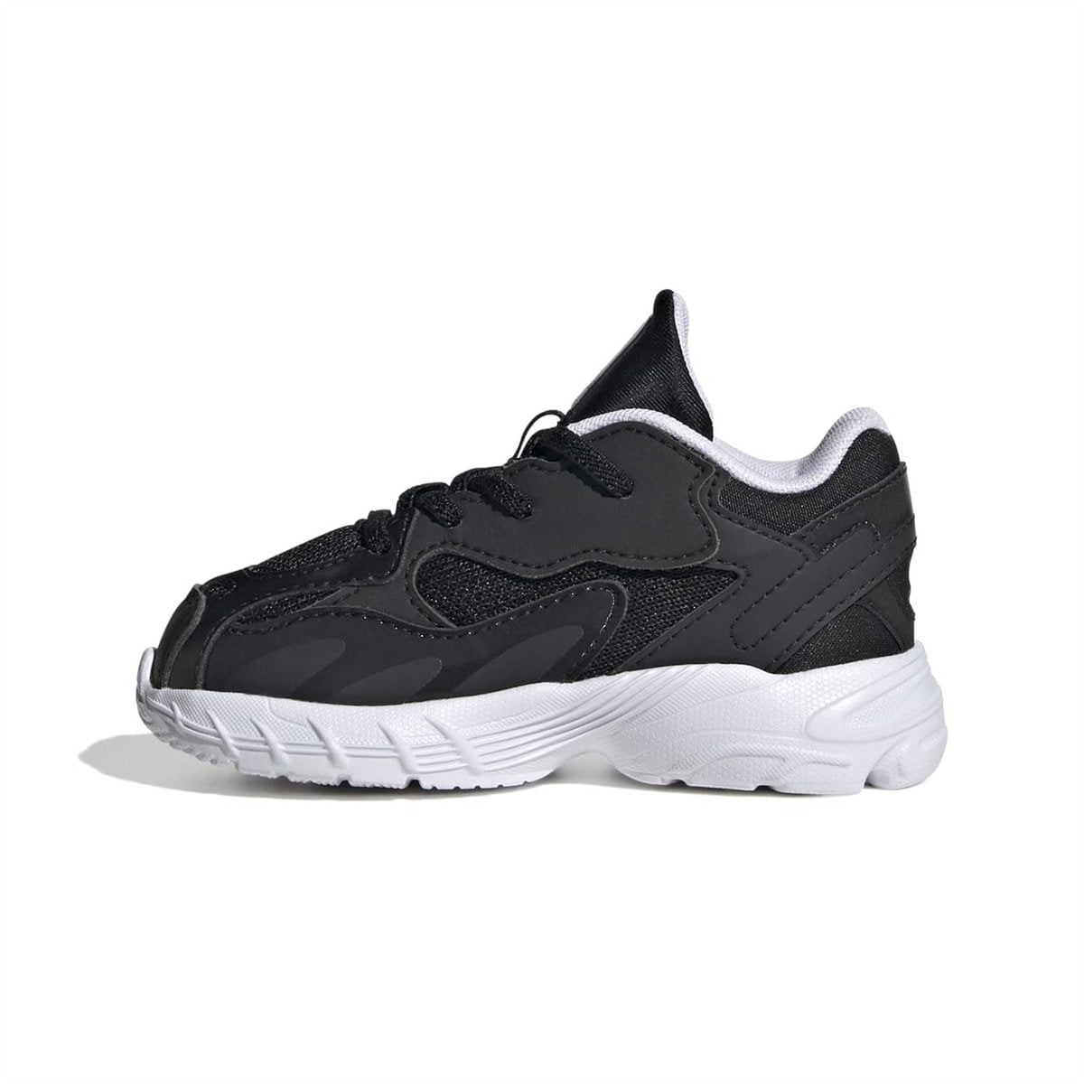 Black low-top trainers with white midsole and stitched overlays, lace-up closure