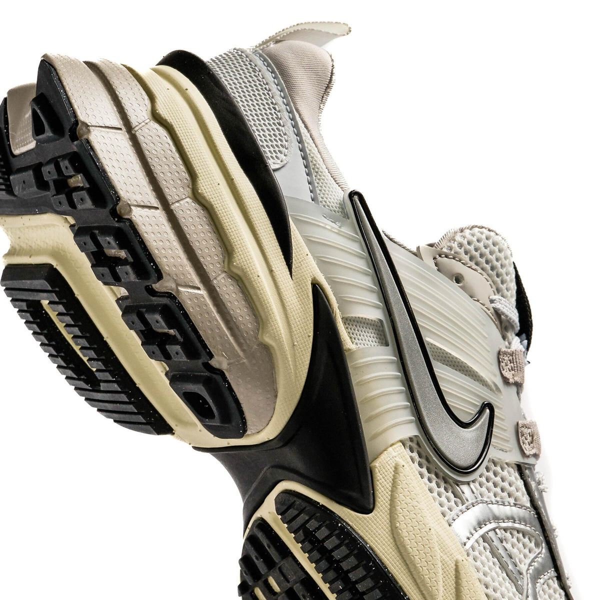 Nike V2K Run sneaker heel and outsole detail in white, silver, beige, with black tread