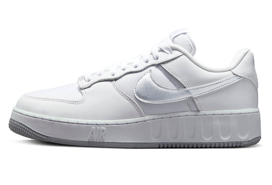 White low-top sneakers with silver Nike Swoosh and lace-up design