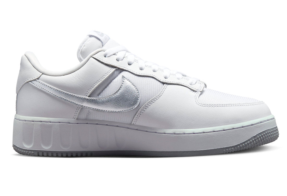 White low-top sneakers with silver Swoosh, padded collar, and lace-up front