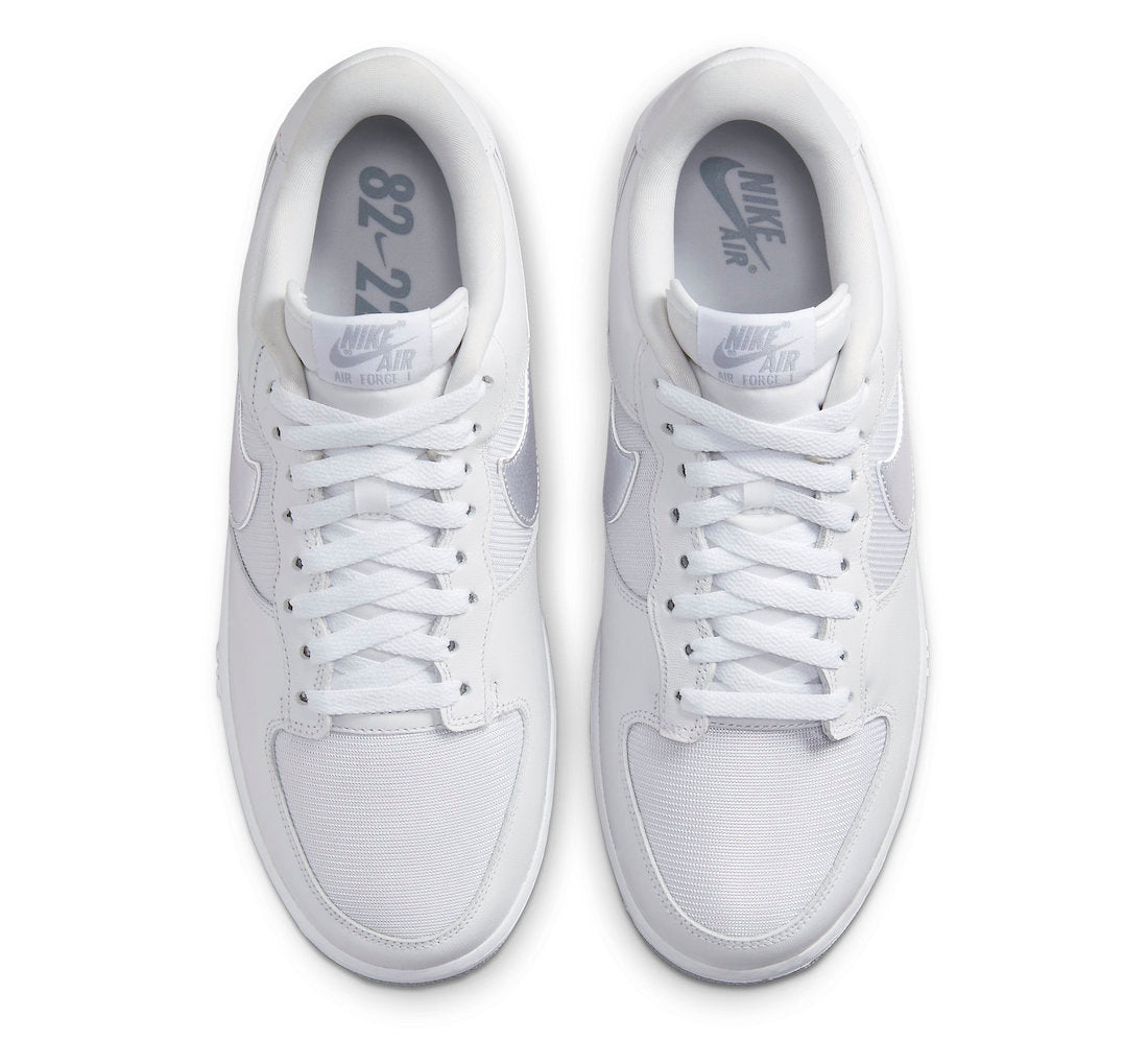 Front view of white lace-up sneakers with Nike tongue labels and white laces