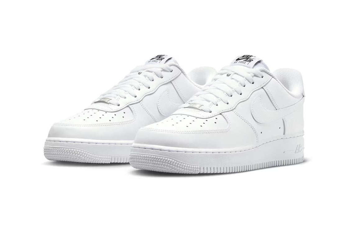 Nike Air Force 1 low-top sneakers in white, lace-up Swoosh, two-shoe side view