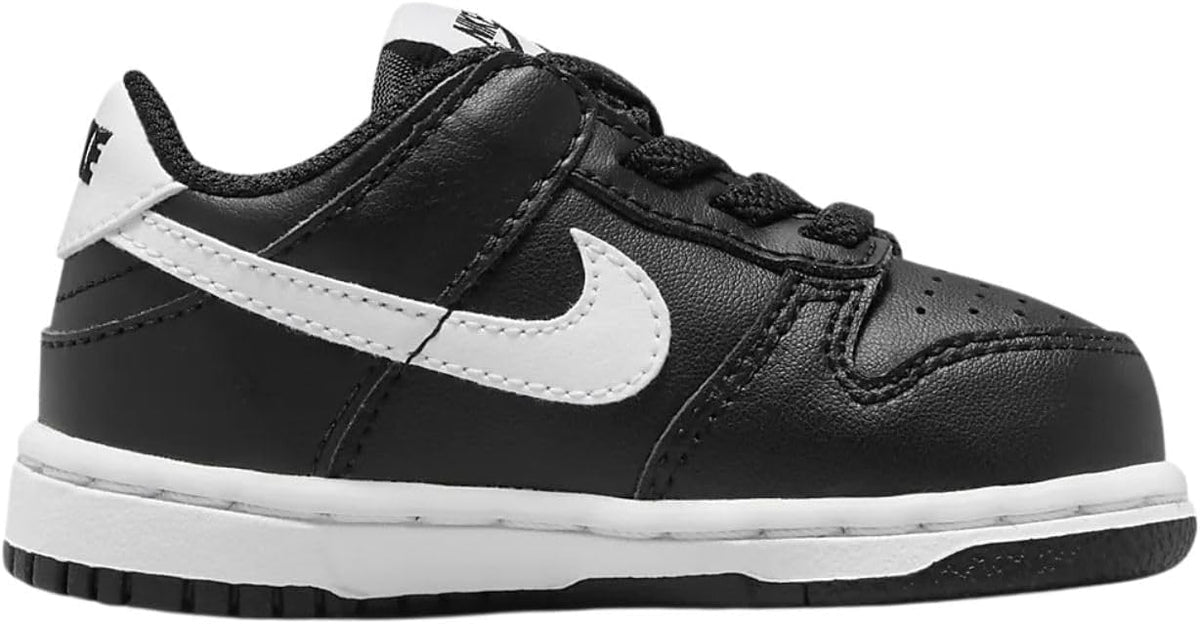 Nike toddler low-top sneakers side view, black upper with white swoosh and heel tab