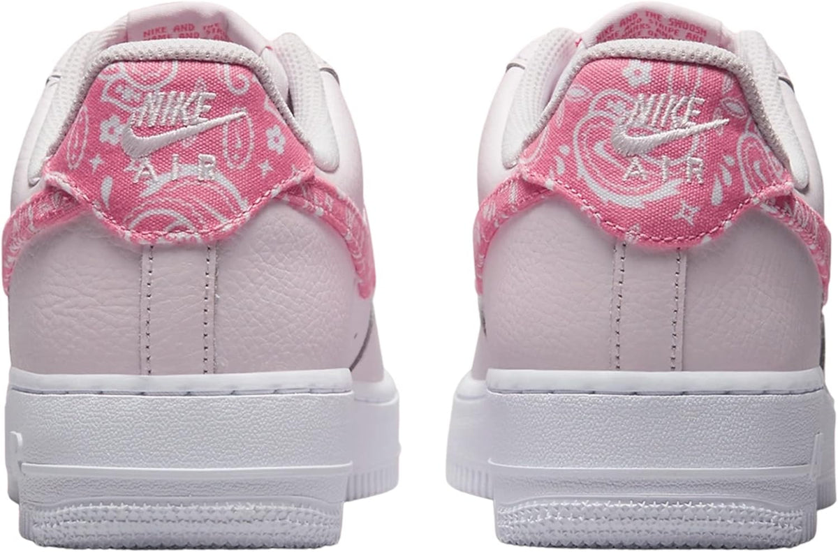 Low-top Nike Air Force 1 sneakers, pale pink with pink patterned heel patch and back tabs