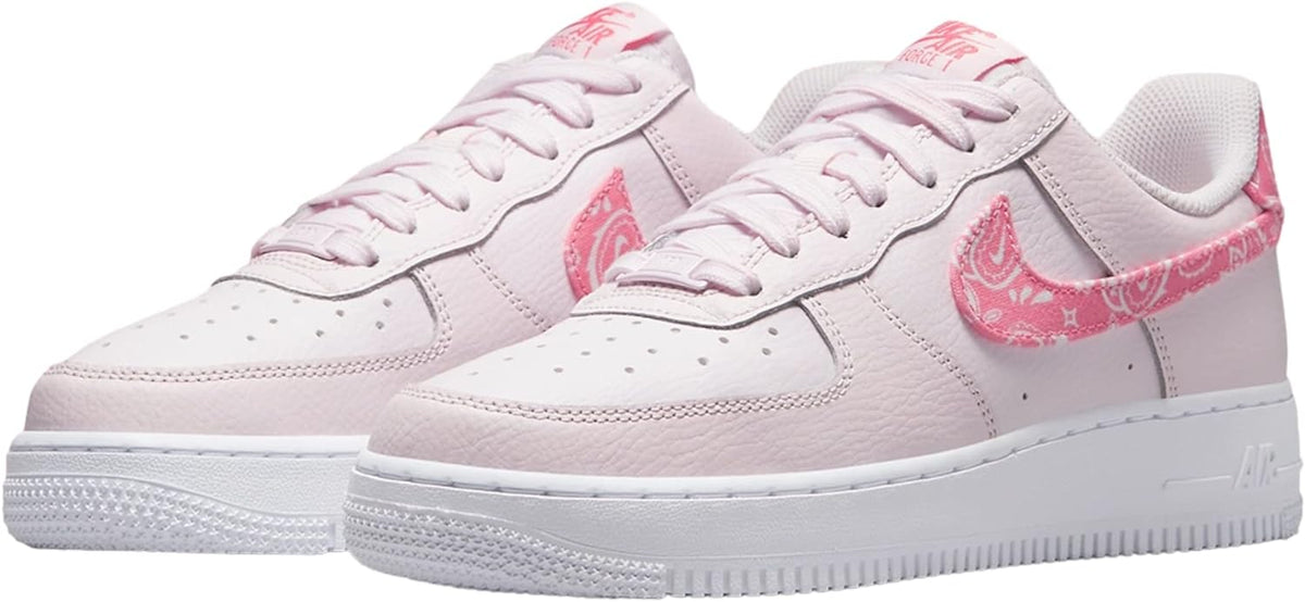 Pair of Low-top Nike Air Force 1 sneakers, pale pink with pink patterned Swoosh