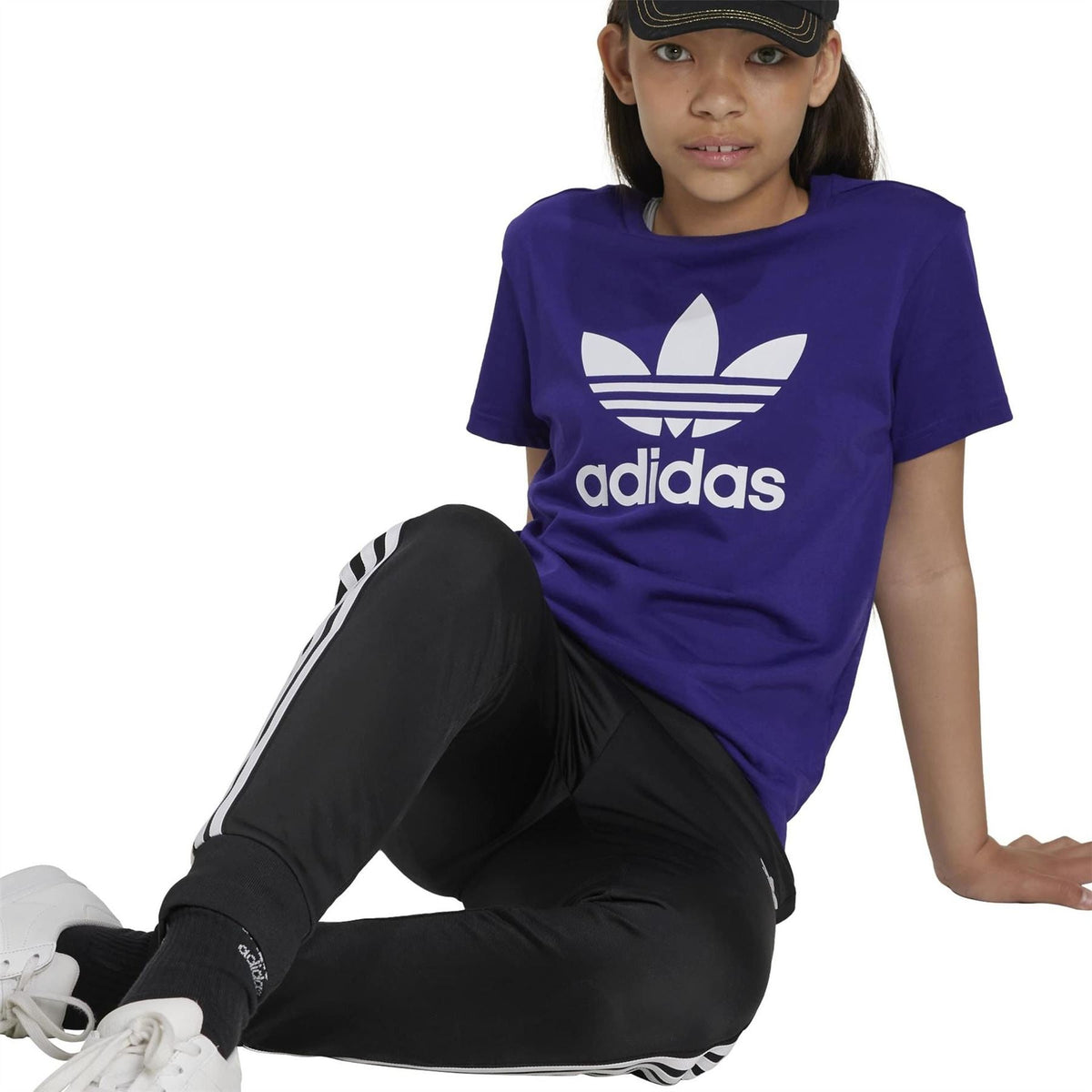Purple crew neck short-sleeve T-shirt with white adidas logo print, seated view