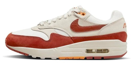 Women's Nike Air Max 1 LX sneakers in sail and orange, side swoosh and visible Air unit