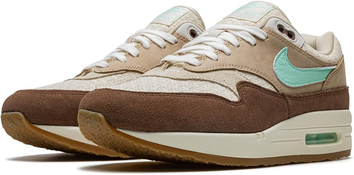 Nike Air Max 1 PRM sneaker pair, angled view with mint Swoosh and visible Air unit