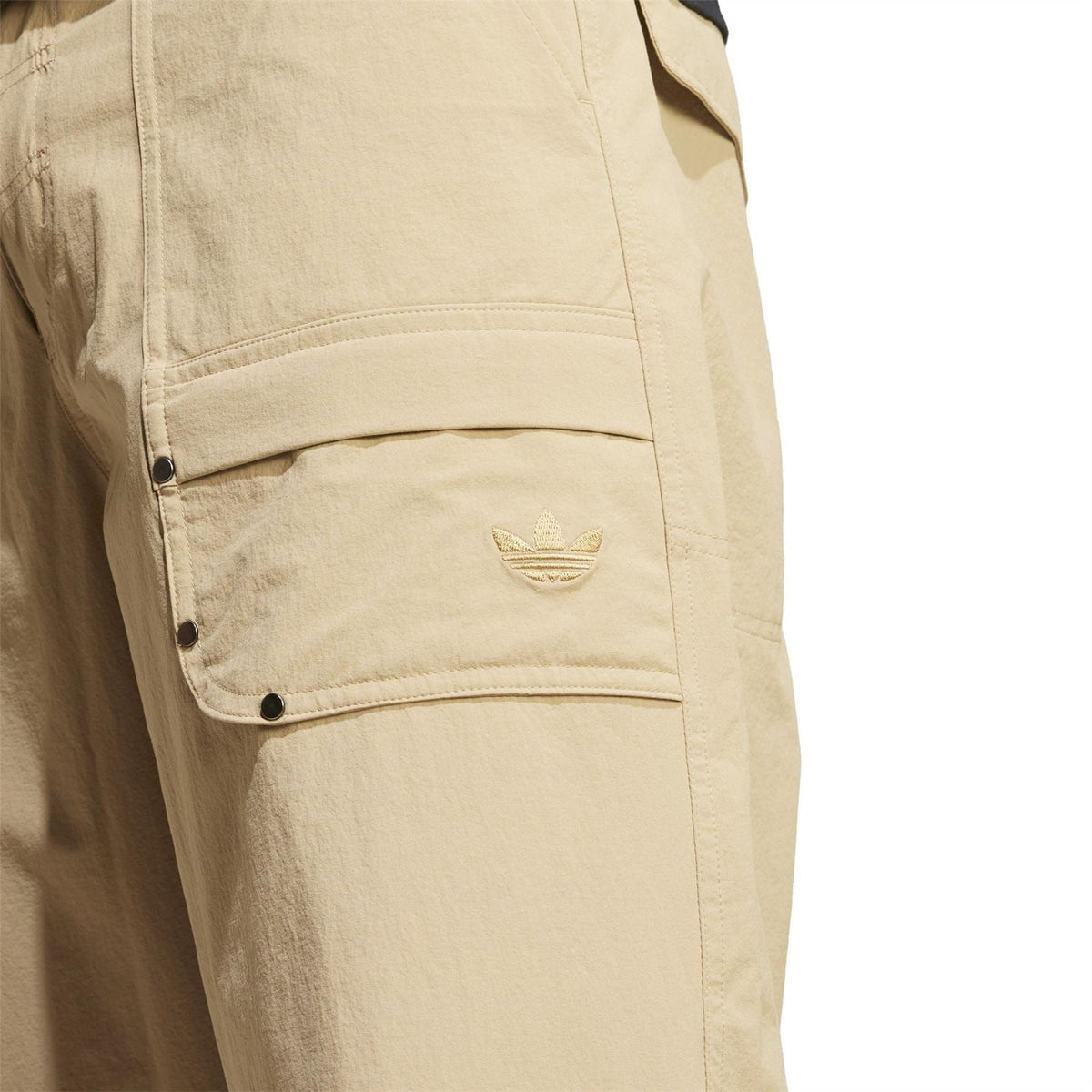 adidas Originals beige pants close-up of logo-embossed flap pocket