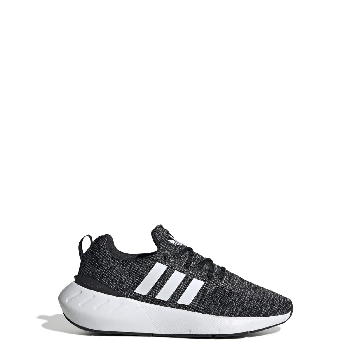 Junior adidas Swift Run 22 trainers, side view with black speckled knit, white stripes, sole.