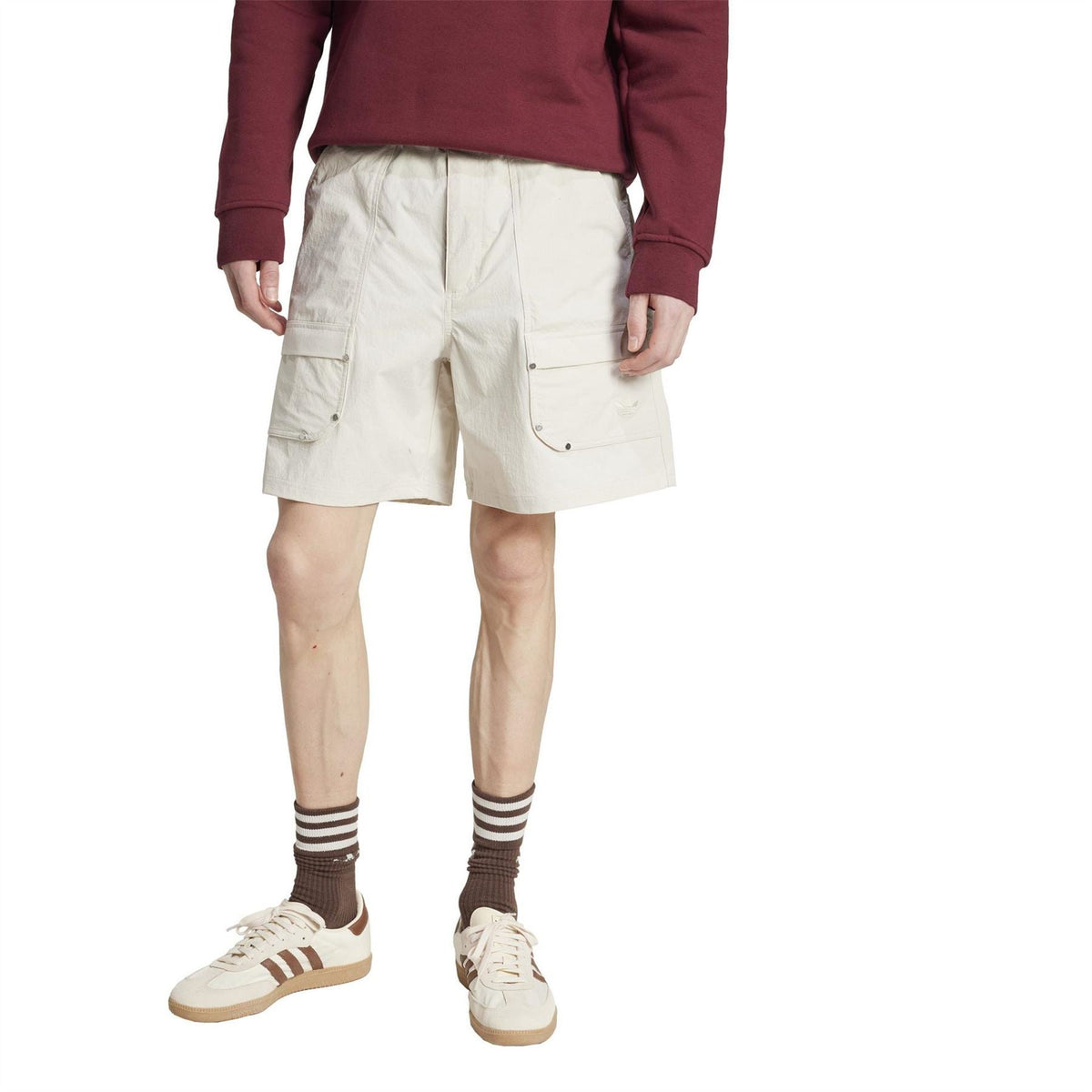 Light off-white utility shorts with cargo flap pockets and adjustable leg-length fit