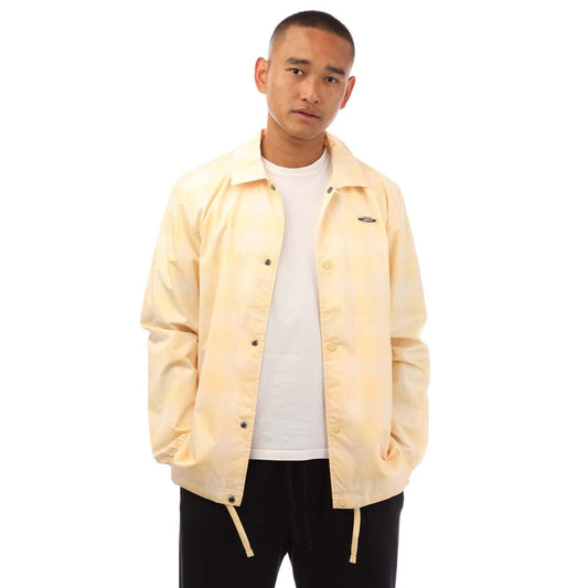adidas coach jacket in light yellow with stand collar, snap buttons, and chest logo
