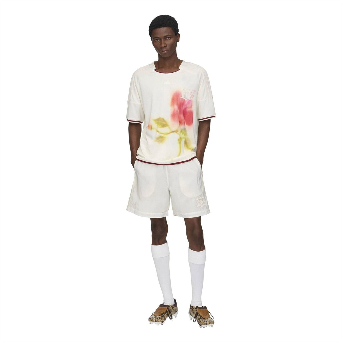 White football jersey with floral watercolor print and burgundy trim, worn with matching shorts