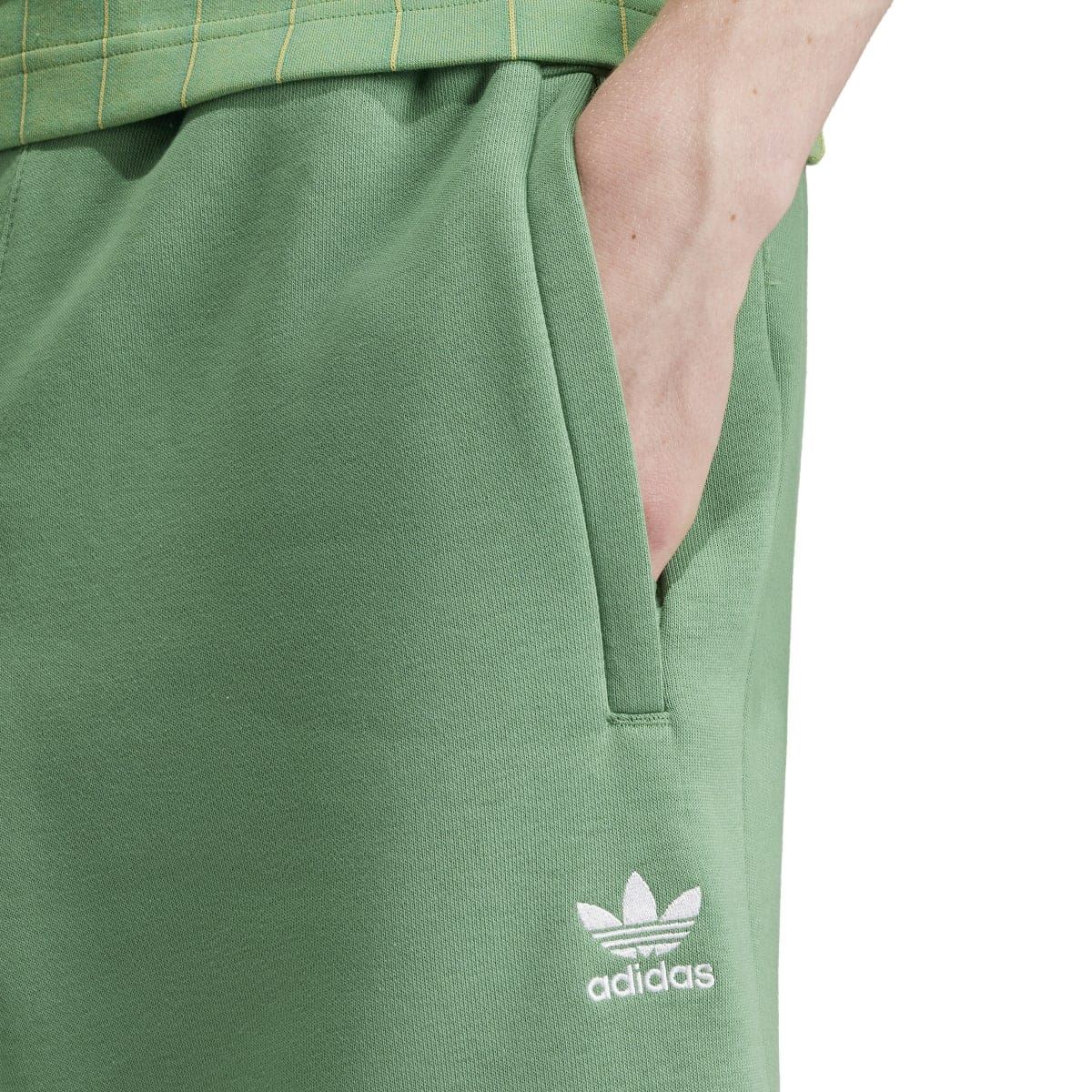 Close-up of green adidas trefoil shorts with drawstring-style waist and logo