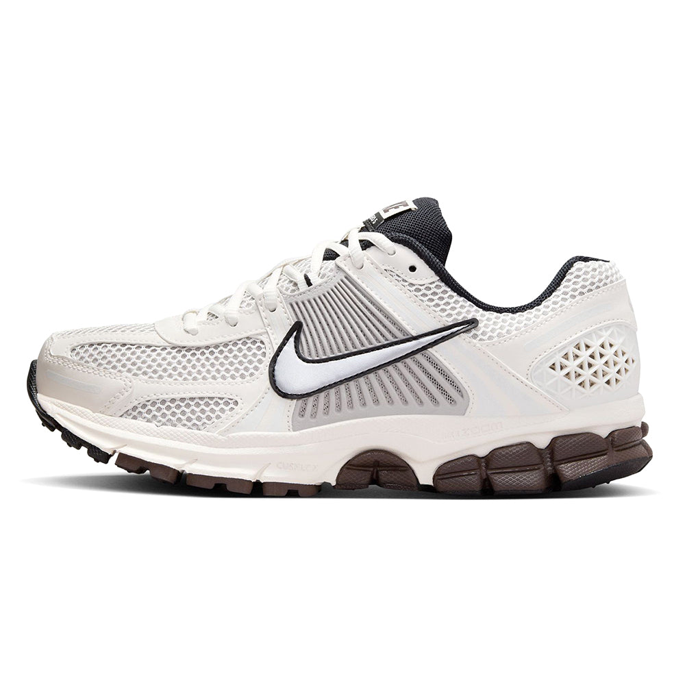 Women’s Nike running shoes in white with black swoosh and brown outsole