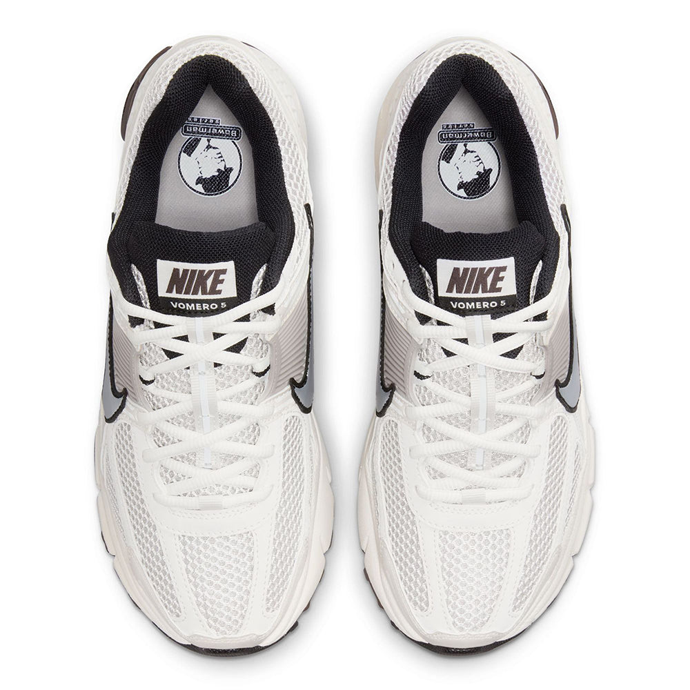 Women’s Nike sneakers with white mesh upper, black lining, and lace-up