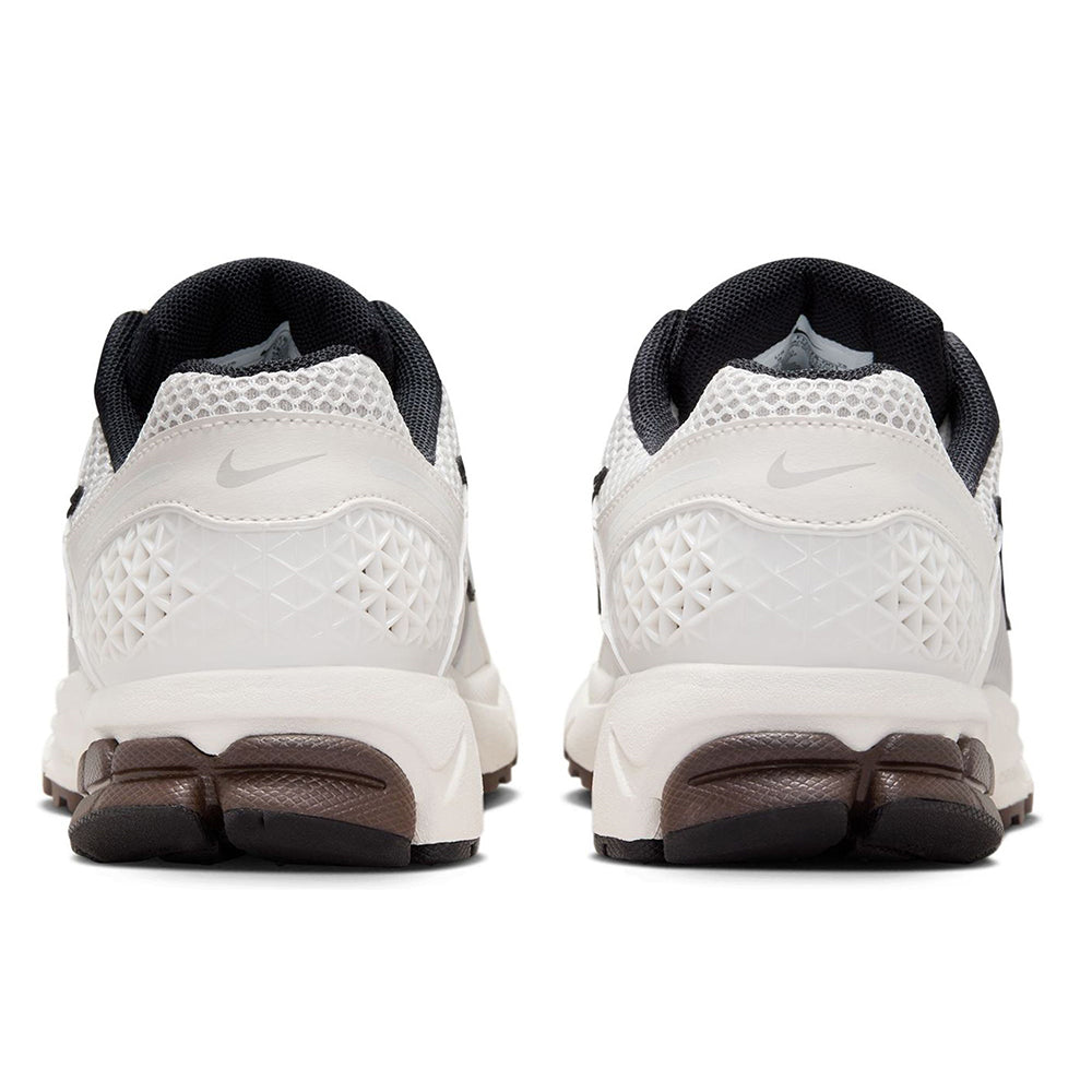 Women’s Nike sneakers heel view with white overlays and dark brown heel accents