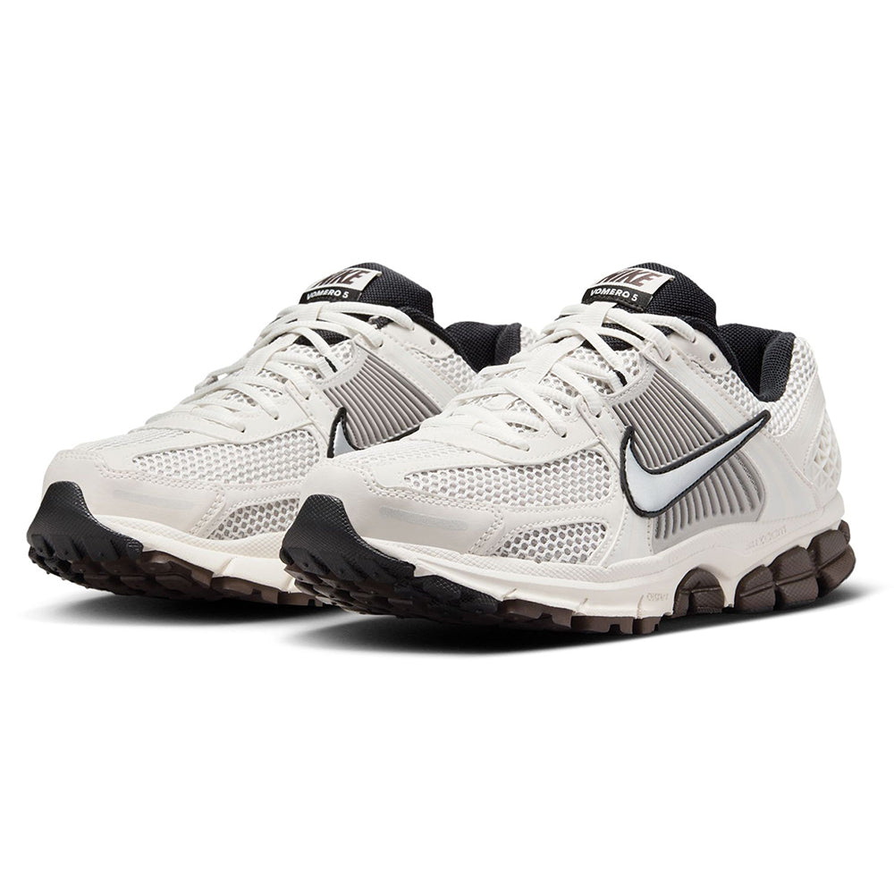 Women’s Nike sneakers angled view with white mesh upper and black collar accents