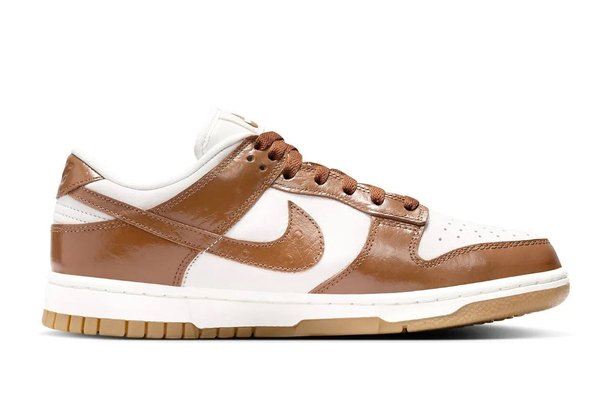 Women's Nike Dunk Low LX sneakers, side view in white and tan with brown swoosh