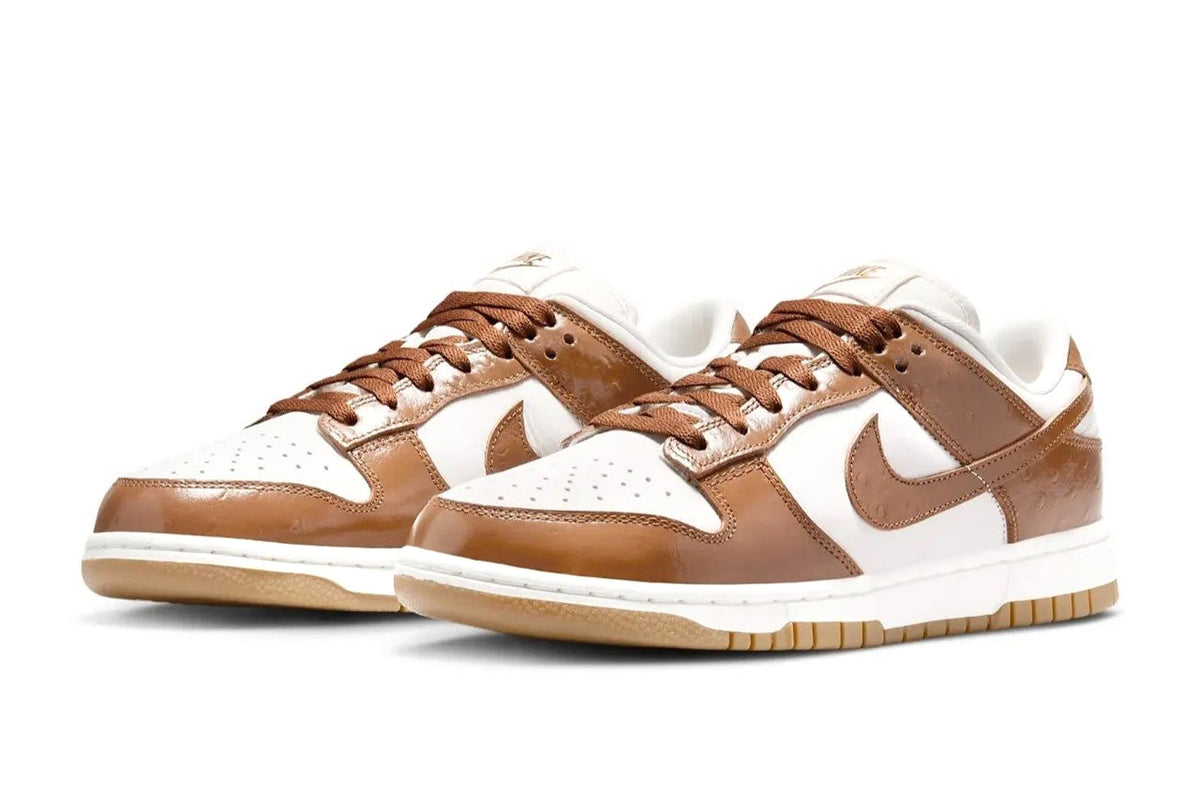Women's Nike Dunk Low LX sneakers, front view with white base and brown leather overlays
