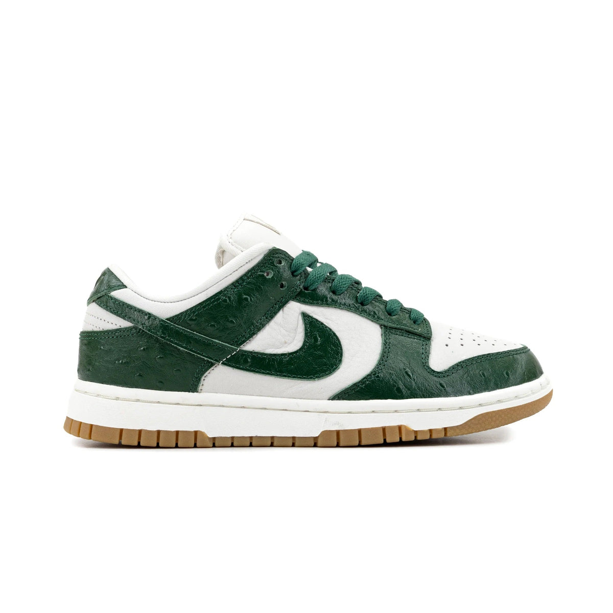 Women's low-top sneakers in white and dark green with Nike swoosh and green laces.