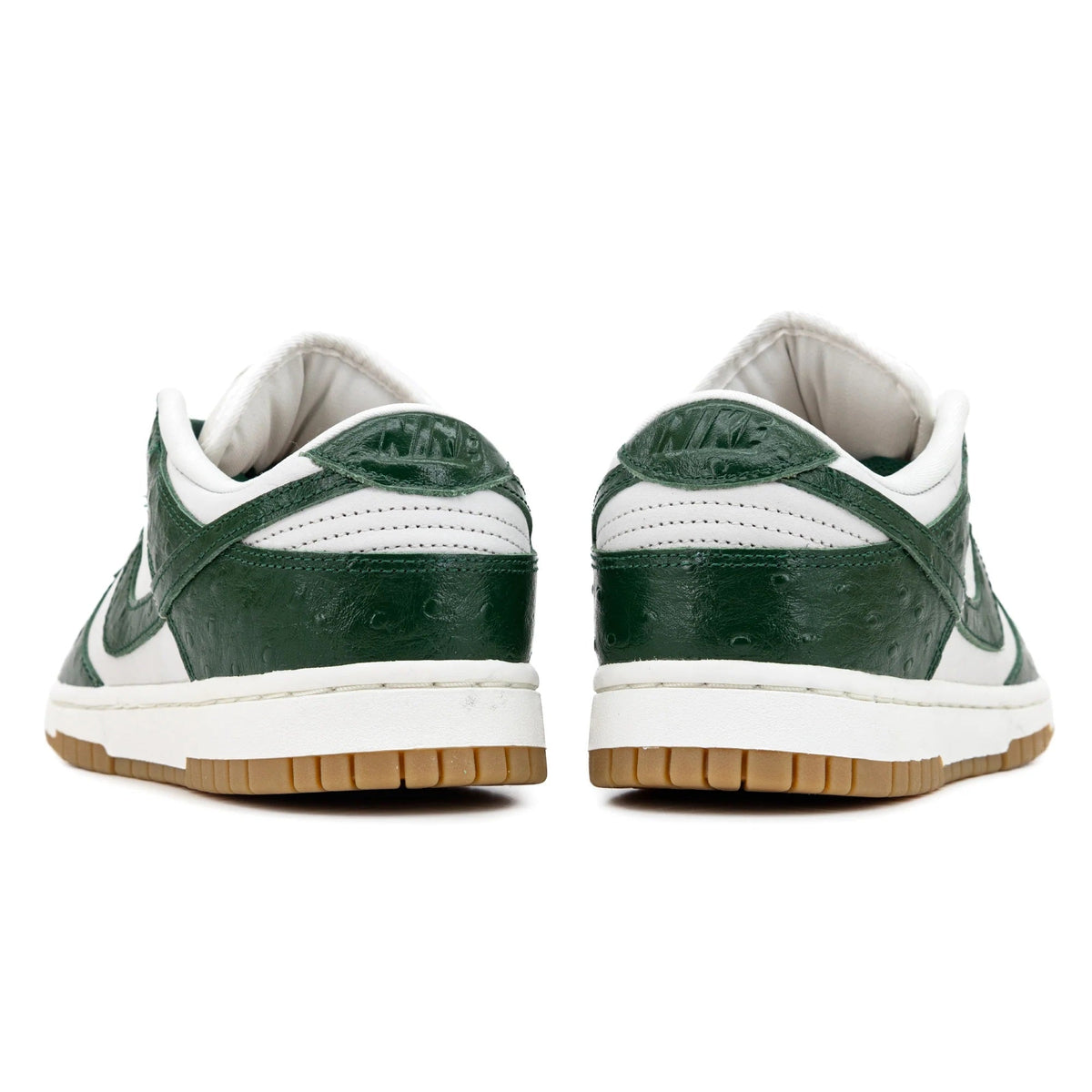 Women's low-top sneakers, white heel tabs with dark green back panels and gum sole.