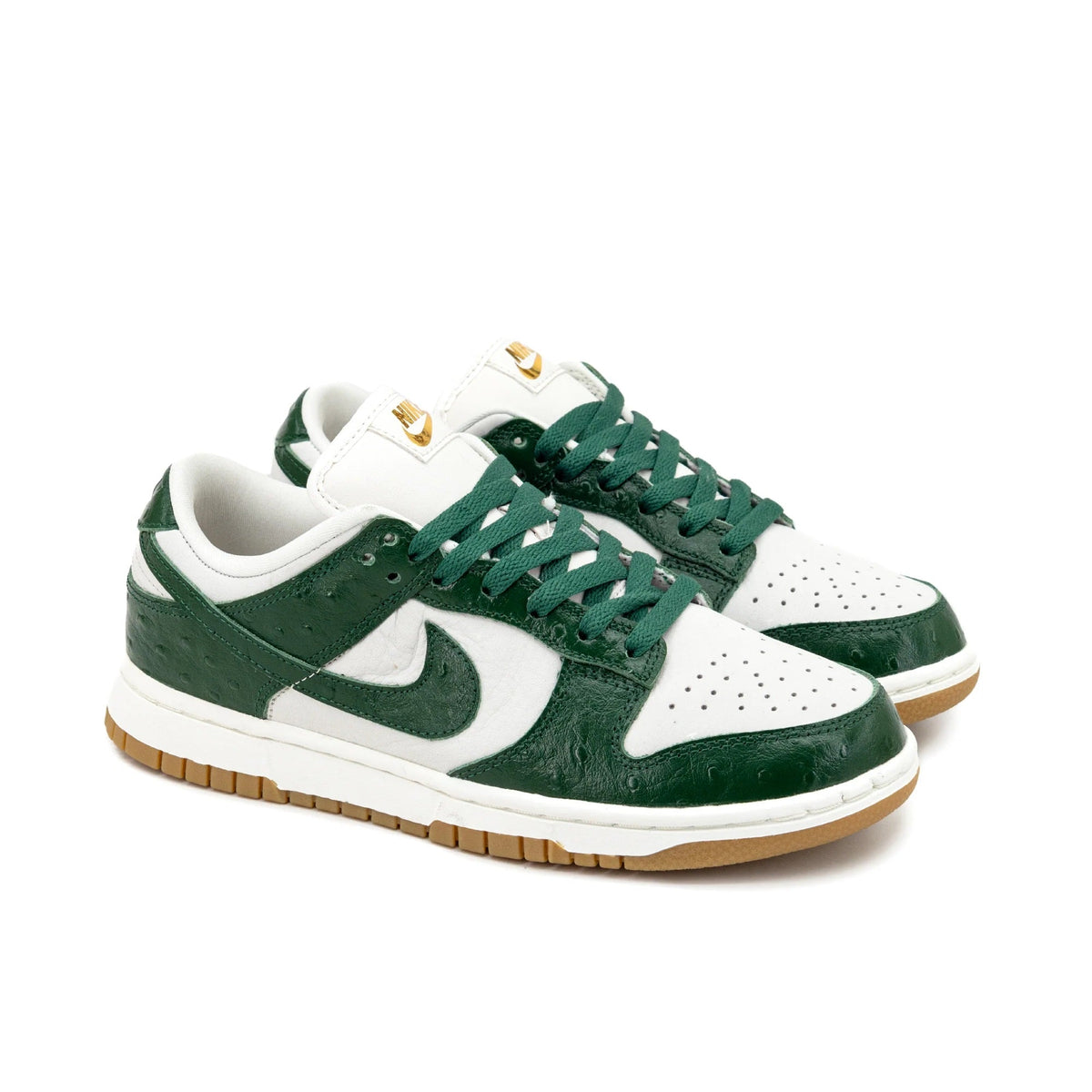 Women's low-top sneakers, white and dark green, large swoosh, green lace-up design.