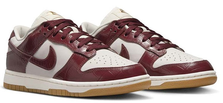 Nike Dunk Low sneakers, burgundy uppers with white swooshes and tan/gum soles