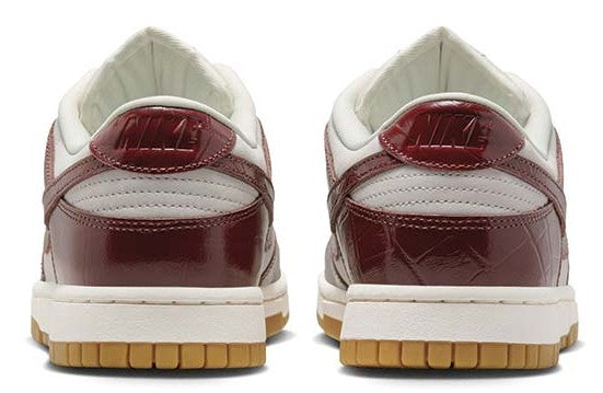Women’s Nike Dunk Low sneakers, heel view with burgundy leather panels and gum soles
