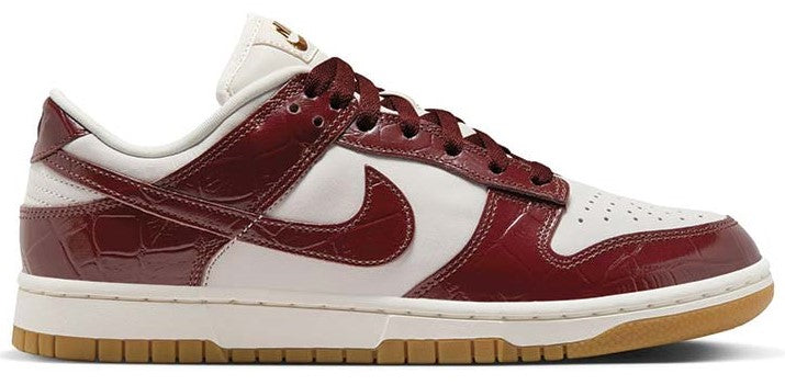 Women’s Nike Dunk Low sneakers with burgundy leather, white swoosh, and gum sole