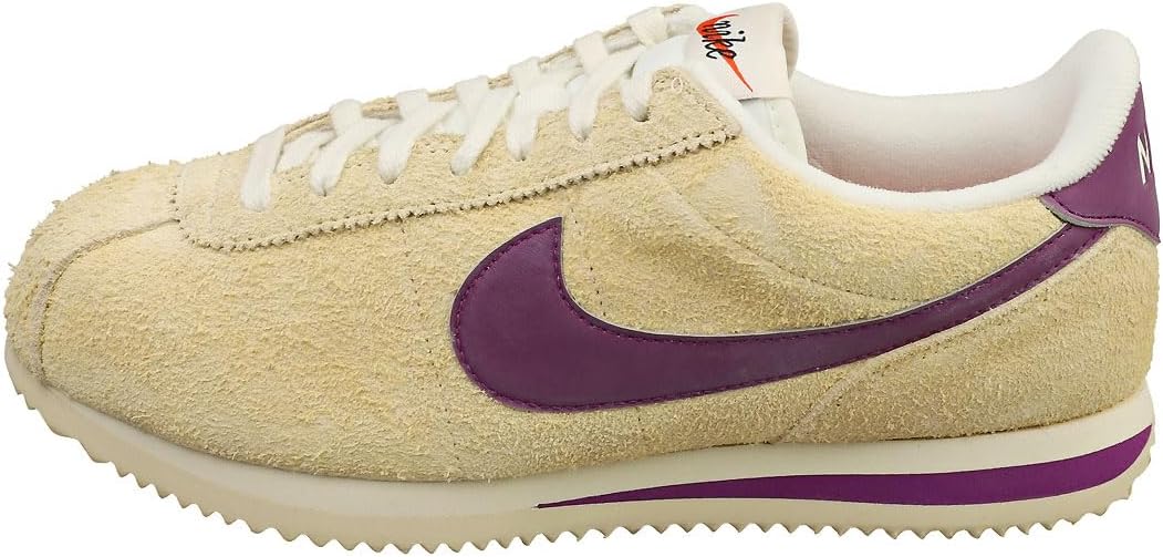 Women's Nike Cortez sneakers in tan suede with purple side Swoosh and cream laces.