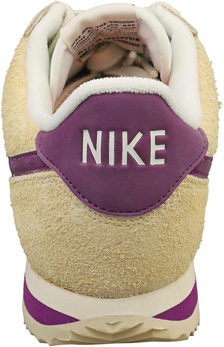Women's Nike Cortez sneakers with tan suede heel and purple back tab with NIKE logo.