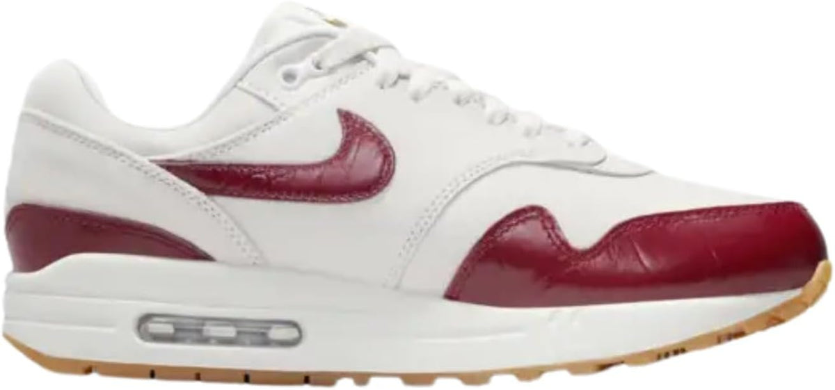 Nike Air Max 1 LX sneakers, side view in sail white with team red Swoosh and air unit
