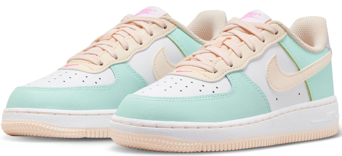 Pair of kids' low-top sneakers in mint and white with pinkish lace trim