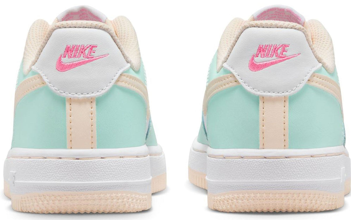 Kids' heel view sneakers in mint and white with Nike logo on beige collar