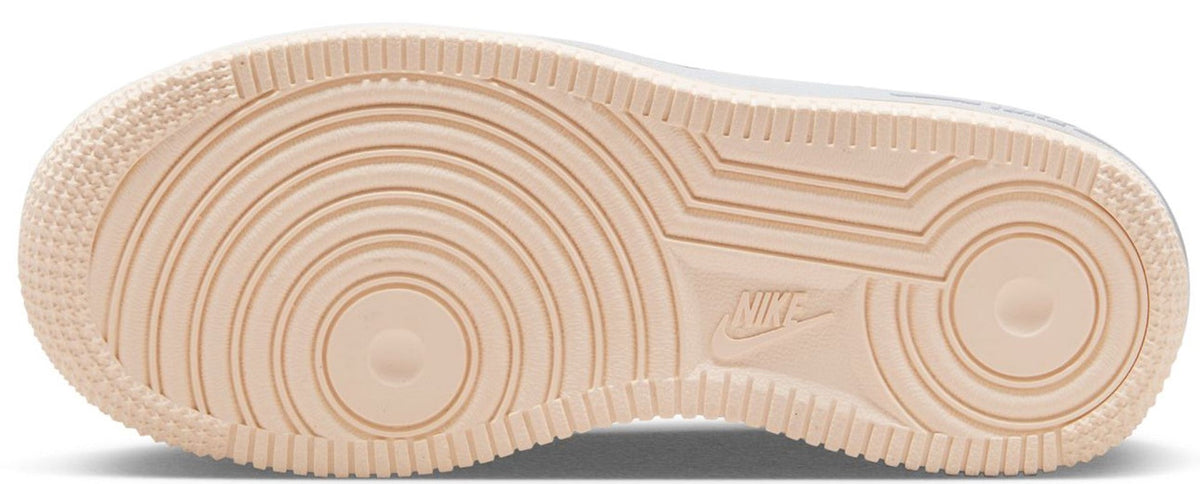 Kids' sneaker rubber outsole in light gum with tread lines and Nike mark