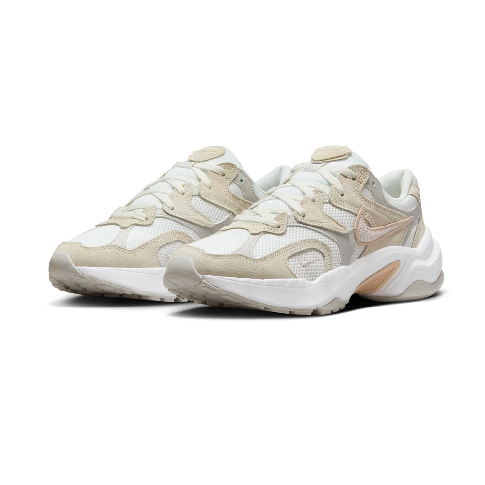 Nike women's running sneakers pair, light bone with tan logo accents, white sole