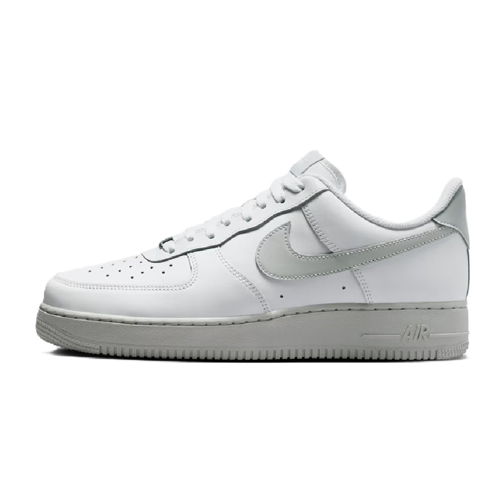 Nike low-top Air sneaker, side view, white leather with gray Swoosh and laces