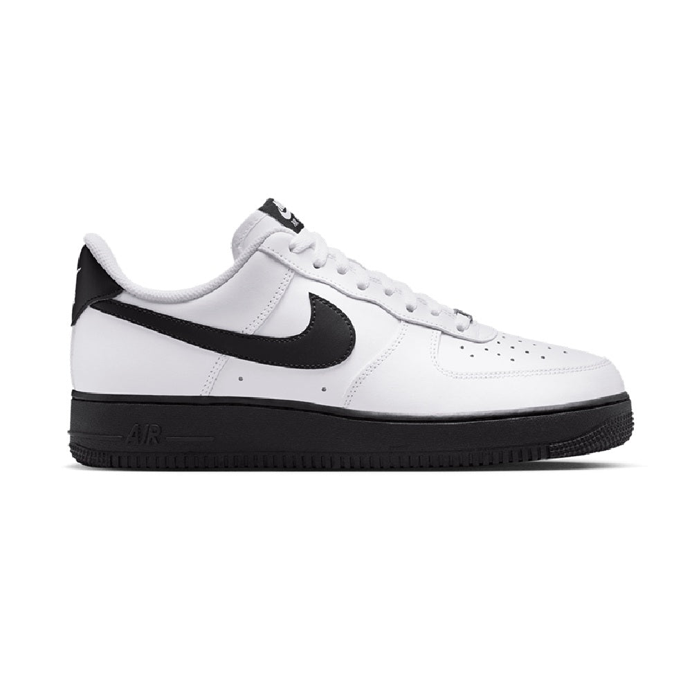 White low-top sneakers with black swoosh panel and black outsole; lace-up.